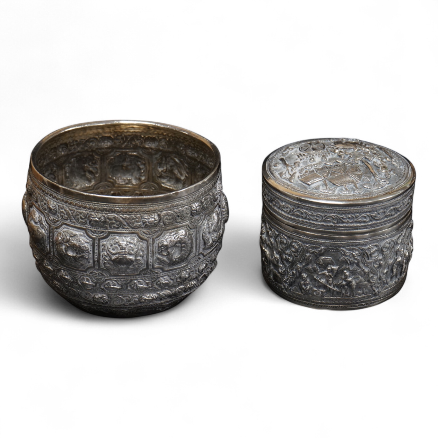 A Burmese embossed white metal circular bowl, signature to the base, diameter 11.4cm, together with a similar circular box and cover, 17oz.